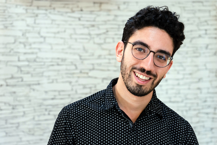 Yoni Battat, white man with glasses and dark hair and short beard, smiling