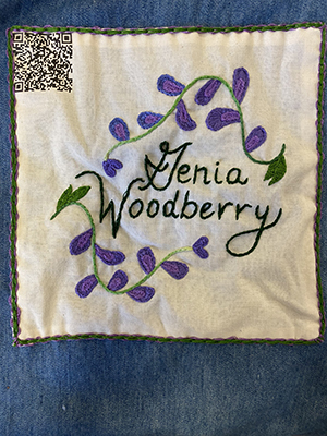 Sewn patch with the name Genia Woodberry