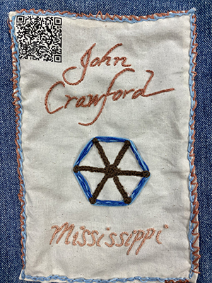 Sewn patch with the name John Crawford