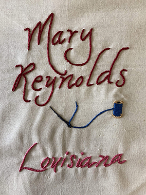 Sewn patch with the name Mary Reynolds