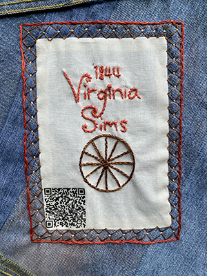 Sewn patch with the name Virginia Sims