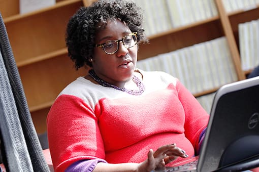 student typing at computer