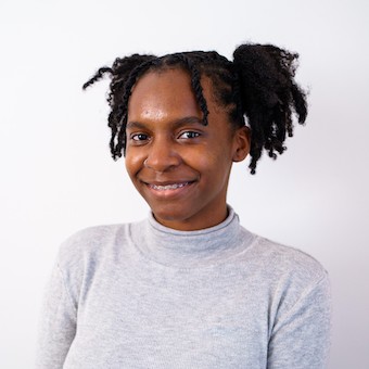 Jalyn Allen smiles in a gray turtleneck.