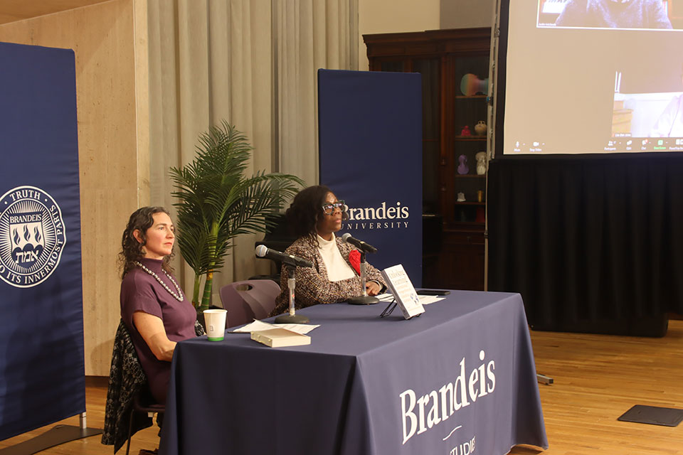 Professor Williams sitting at a table during the Unlocking Learning Panel.