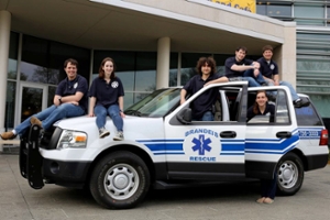 EMTs sitting on top of a EMT vehicle