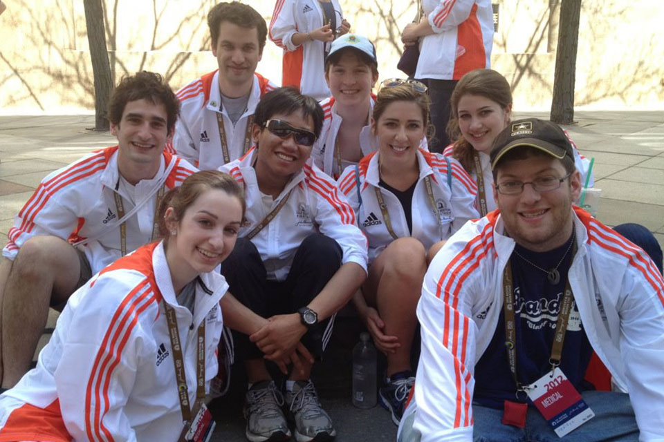 BEMCo members sit on the ground at the Boston Marathon