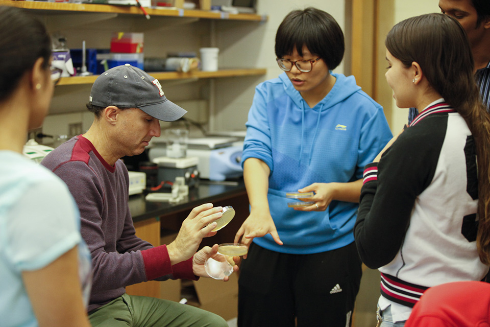 Professor and several students working in a Biotechnology lab