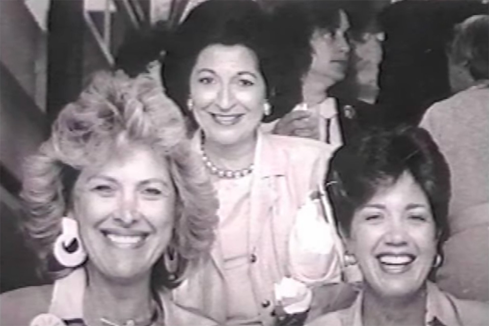 Black and white photo from the 80s of three women smiling