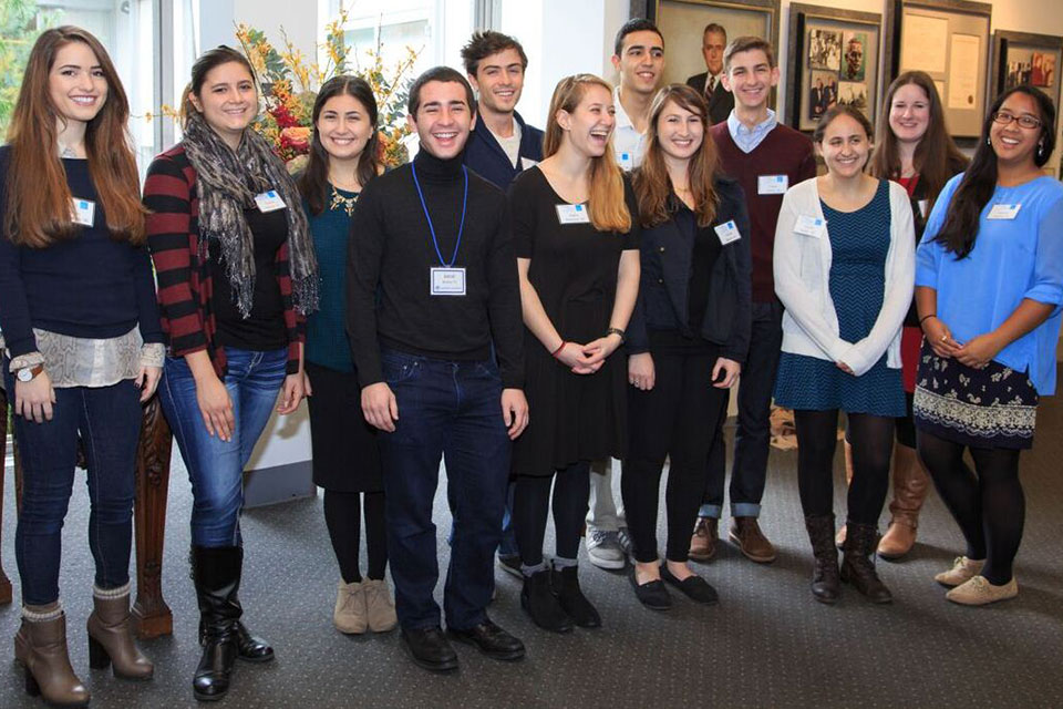 Smiling group of students wearing nametags