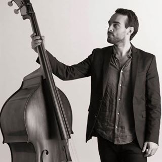 James Heazlewood-Dale stands next to a bass