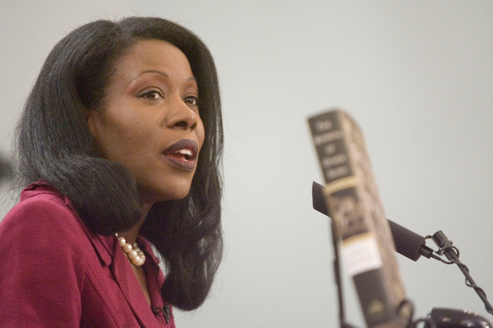 Isabel Wilkerson speaking at a microphone