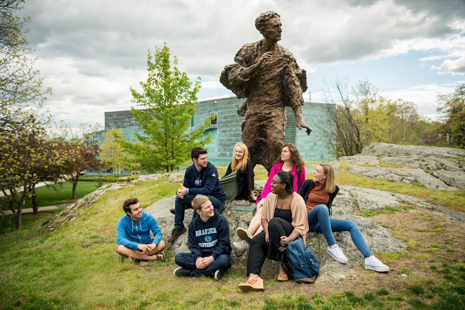 Students sitting in front of the statue of Louis Brandeis
