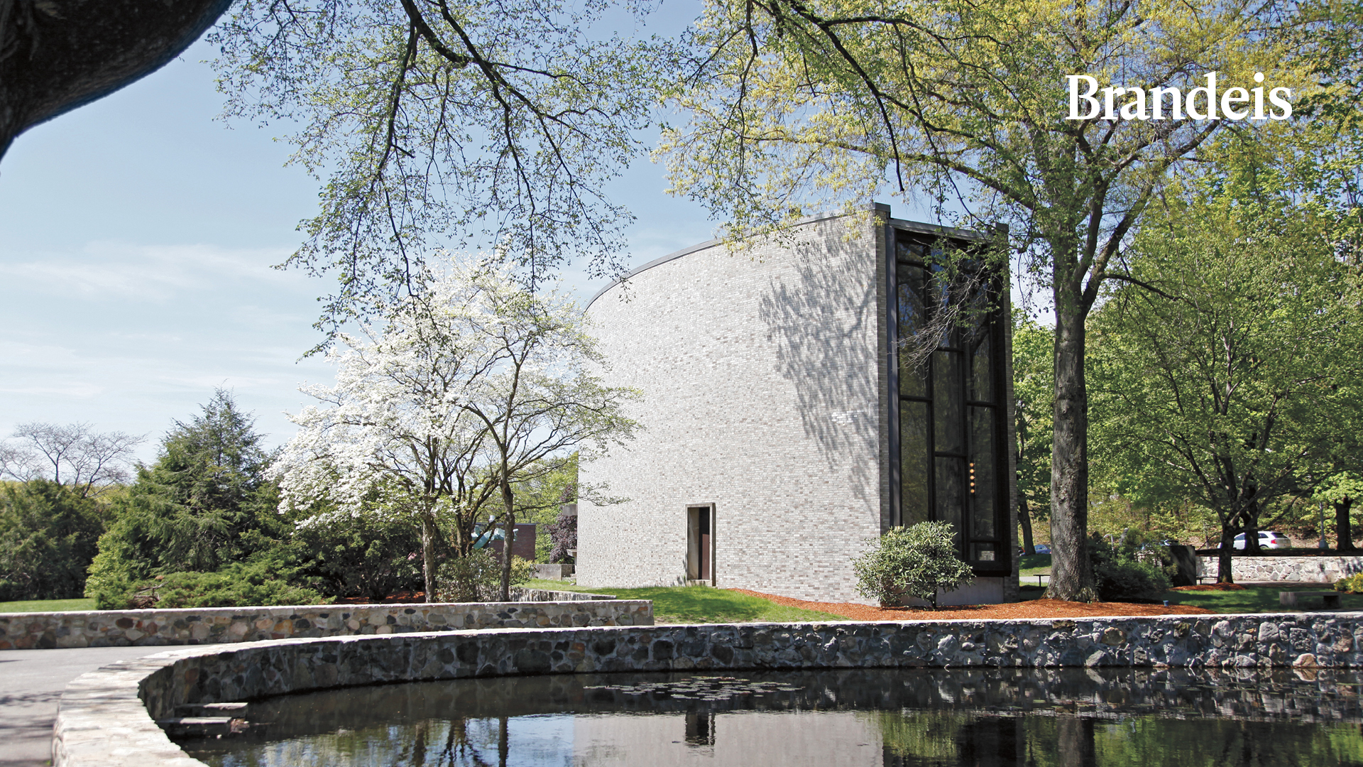 Pond and chapel with Brandeis logo