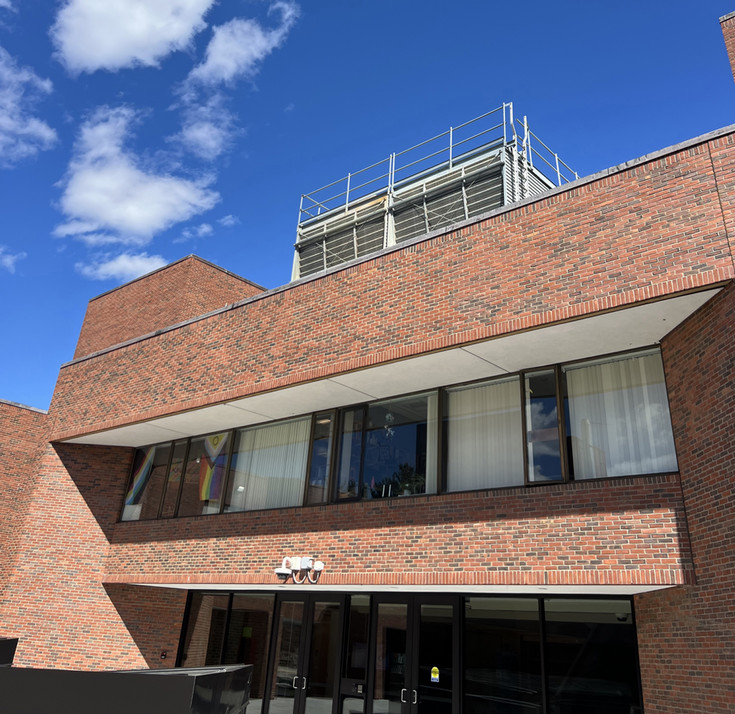 brick building with a square metal piece of equipment on top