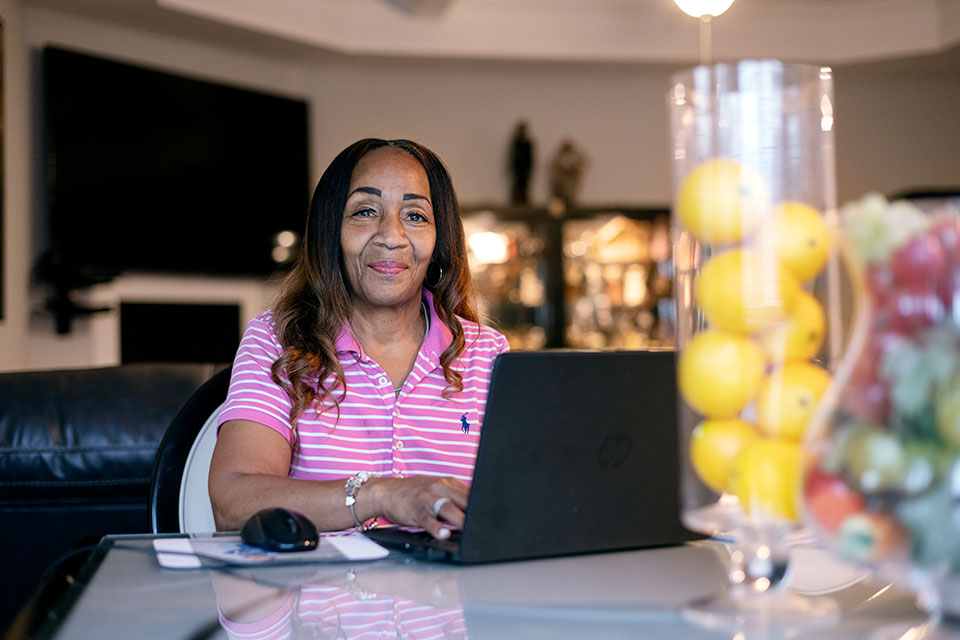 Deborah sitting at a laptop