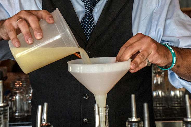 Close up of hands making a cocktail