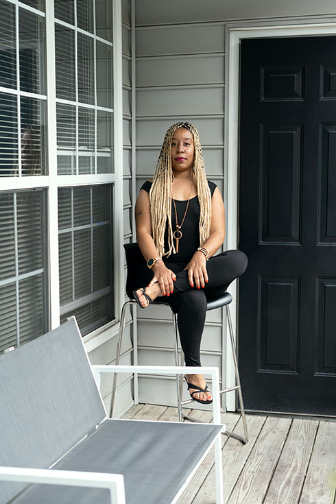 Tonya sits on a chair on a front porch