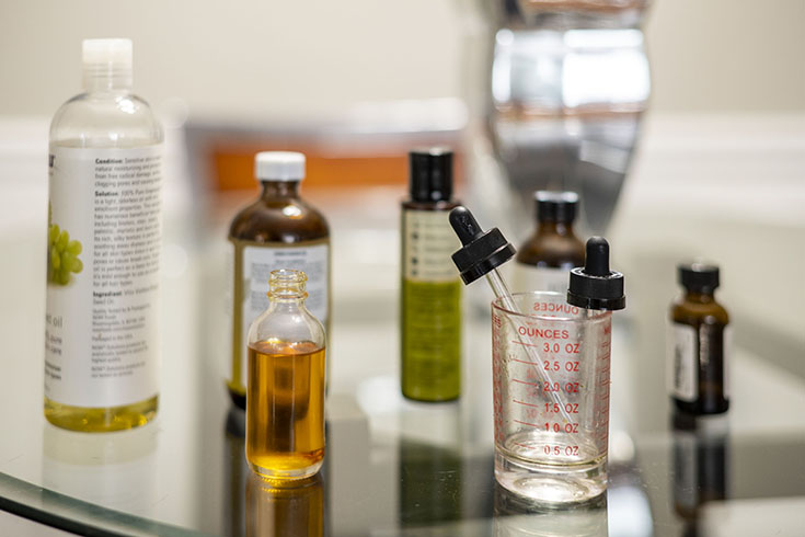 Glass bottles of oils that Tonya uses to make her beauty products