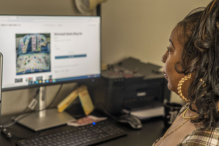 Tonya sits in front of her computer working on her business's website