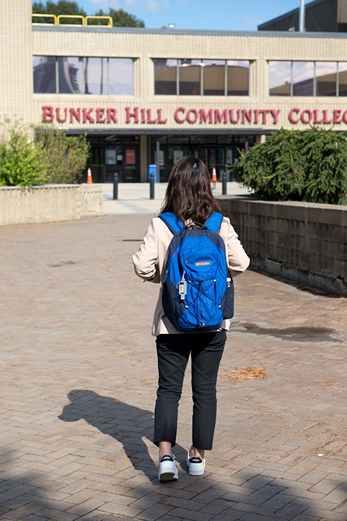 Y.L. from the back, with a backpack on, walking toward Bunker Hill Community College