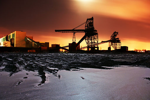 Fossil fuel factory at sunset