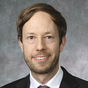 Headshot of Professor Raphael Schoenle smiling