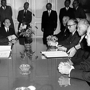 Black and white picture of men around a large table