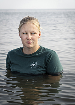 Girl in water looking at camera