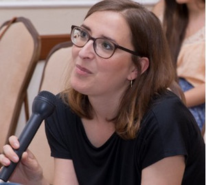 Head shot of Saskia Fischer speaking into a mic