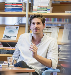 Image of Lukas Hermsmeier sitting in a chair