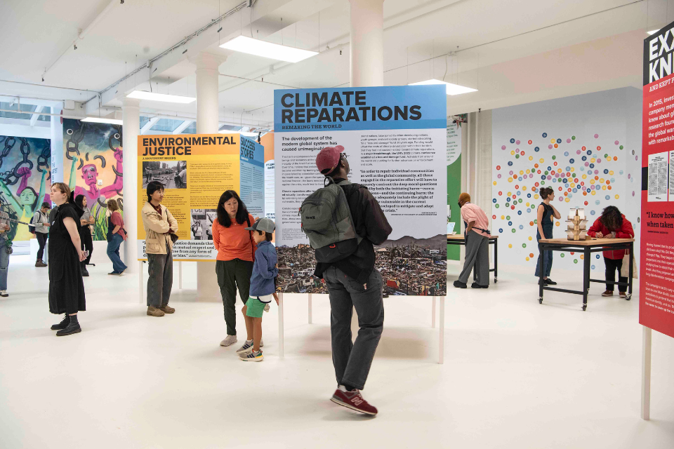 People looking at indoor exhibits of climate change
