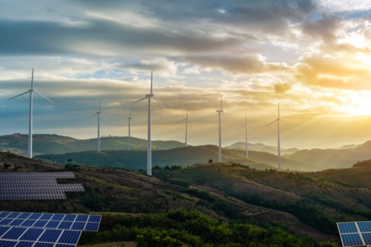 solar cell plant and wind generators under blue sky on sunset