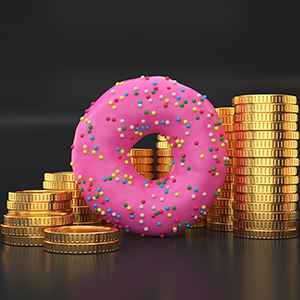 Coins stacked up with a pink frosted donut in front