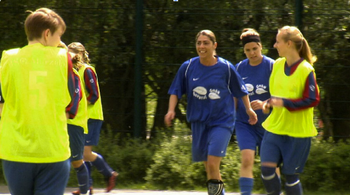Image of some women playing soccer in the sun