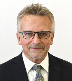 Headshot of Karl looking seriously at the camera