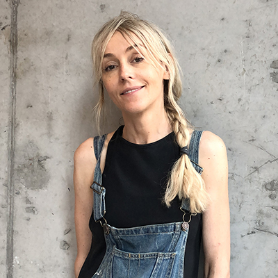 Portrait of Agnieszka Pilat smiling in overalls.