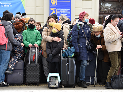 Refugees standing exhausted at a European train station