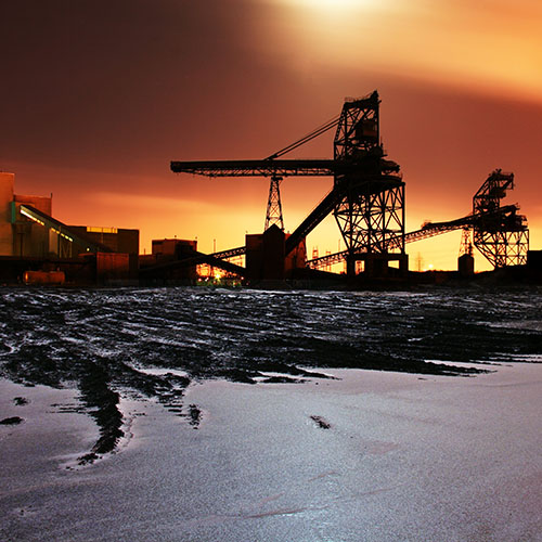 Image of a factory at sunset