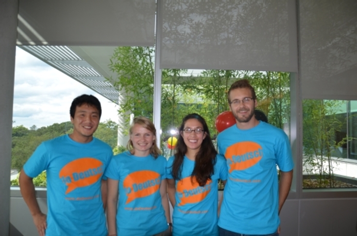Four students wearing event T-shirts for the Welcome Back reception and Day of German Unity