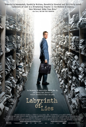 Film poster for "Labyrinth of Lies." Photo is of a man in a suit, holding a briefcase, standing in an aisle of ceiling-high shelving filled with file folders. His head turns to look back at the viewer. Text reads: "Documented, carefully written, forcefully directed and skillfully acted. Labyrinth of Lies' is a devastating chapter in the history of justice, more relevant today than ever. -Rex Reed, the New York Observer. At the bottom above the credits: "In Germany, 15 years after World War II, one young man forces an entire country to face its past. Labyrinth of Lies.
