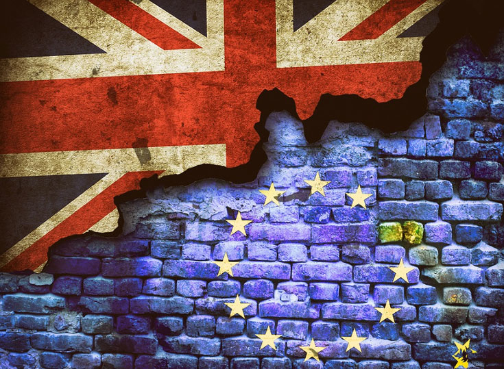 The flag of the United Kingdom and the flag of the European Union superimposed on a brick wall.