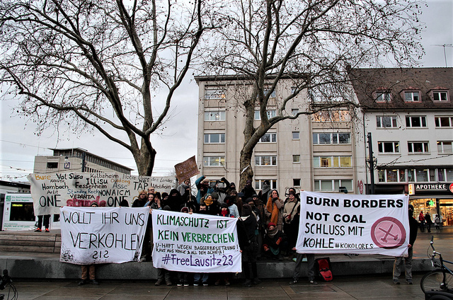 A group of activists holding banners with German climate change slogans