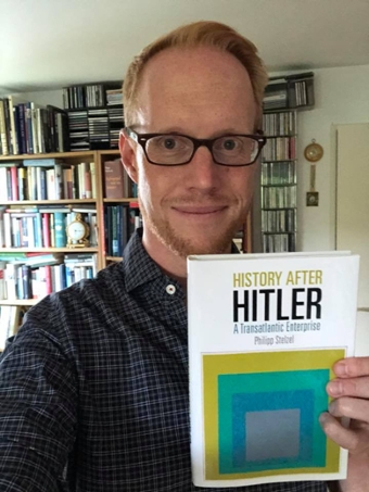 Philipp Stelzel holds his book