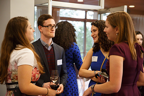 A group of 4 students and CGES alumni chatting during the reception. From left to right: Leonie Koch ’16,  Jonathan Jackson '16, Emma Gutman '18  and Helena Voltmer ’18