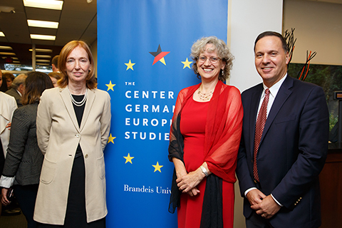 Emily Haber, German Ambassador to the U.S., Sabine von Mering, CGES Director and Ron Leibowitz, Brandeis President posing in front of the CGES banner