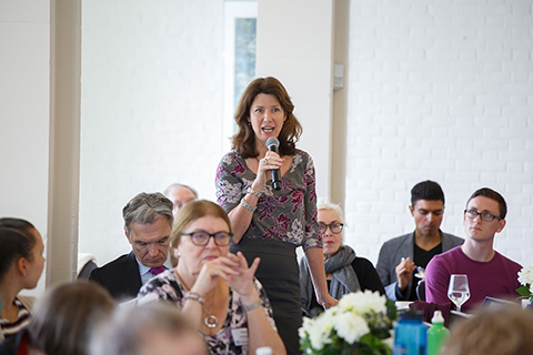 A woman in the audience posing a question to the panel