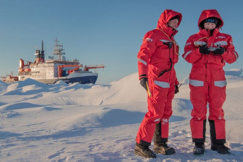 Scientists in orange suits on ice