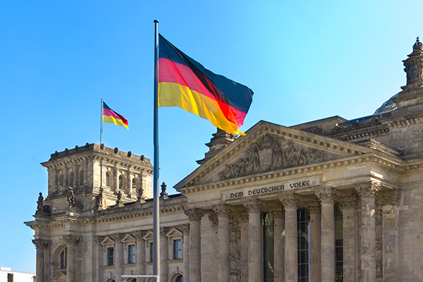 German parliament building with a flag in front