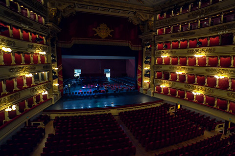 Inside of an opera hall with the lights dimmed