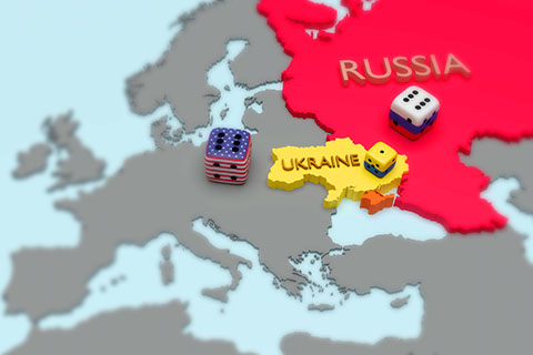 Map of Europe with Russia and EU flags symbolized as dice